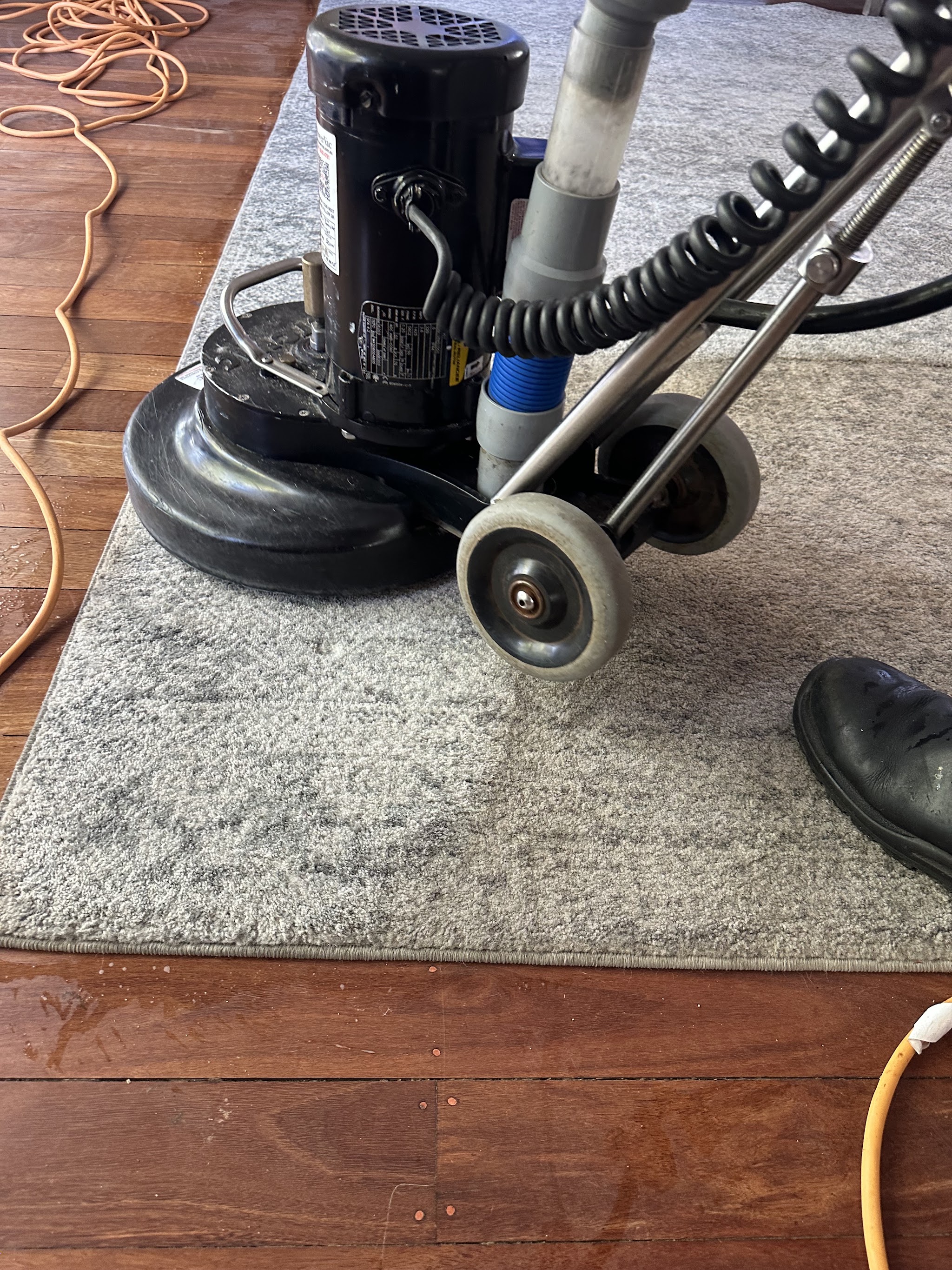 The rotary machine working across a grey rug